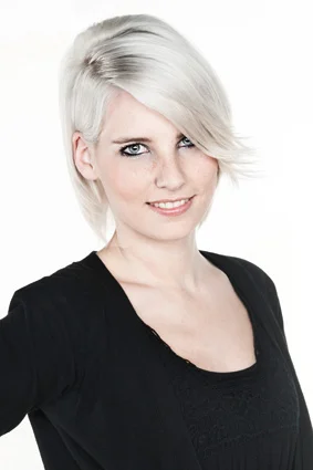 Portrait von einer jungen Frau mit weißen halb kurzen Haaren in einem schwarzen Oberteil