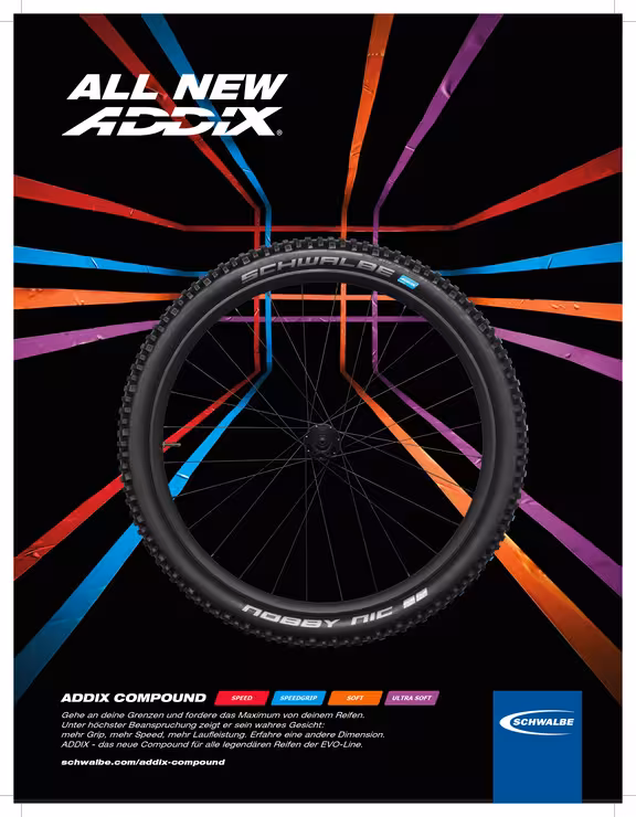 Werbung für Fahrradreifen, Hintergrund schwarz mit bunten Strichen